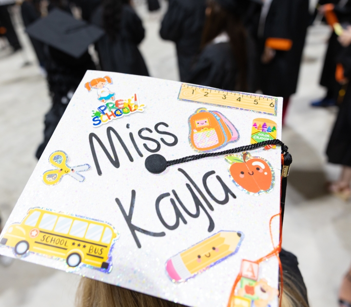 A student's decorated graduation cap reading "Miss Kayla"