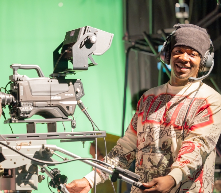 Male student uses video equipment