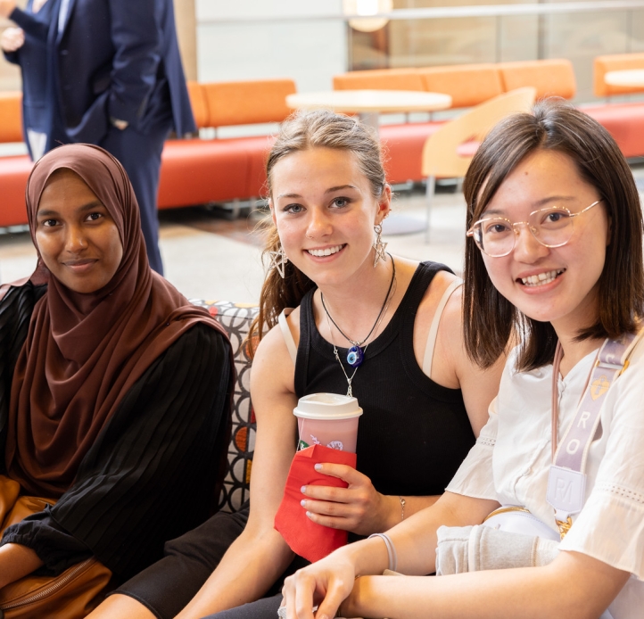 Students smiling and drinking coffee